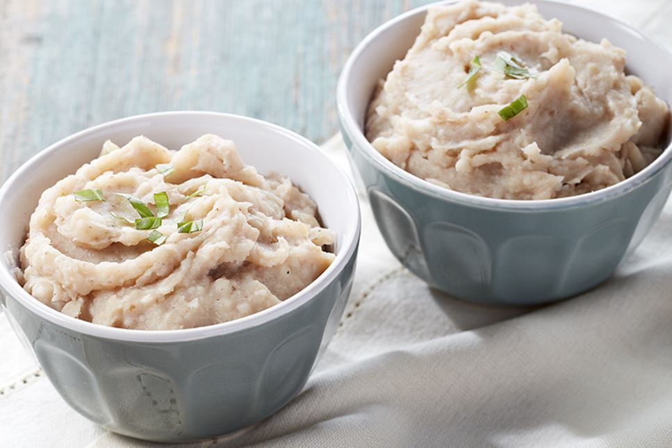 Two bowls of Creamy Cauliflower Pinto Mashed Potatoes