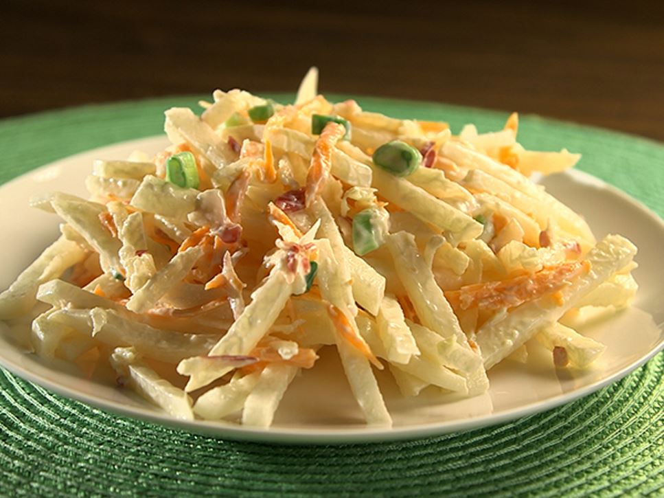 A plate on a table of jicama apple slaw