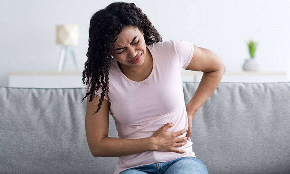 woman with pain in lower back and side area near kidneys