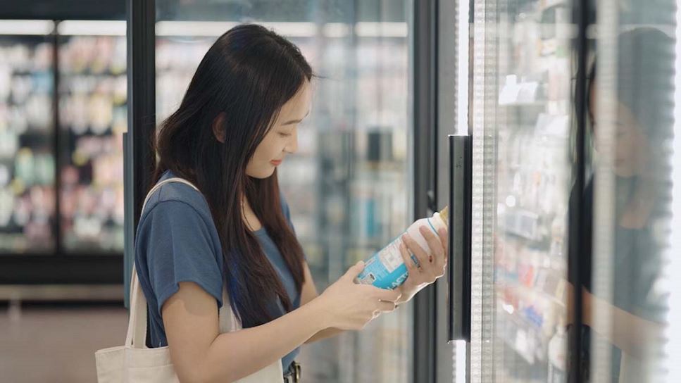 Understanding the Nutrition Facts Panel A Guide to Healthier Eating | Woman in Grocery Store Looking at Item